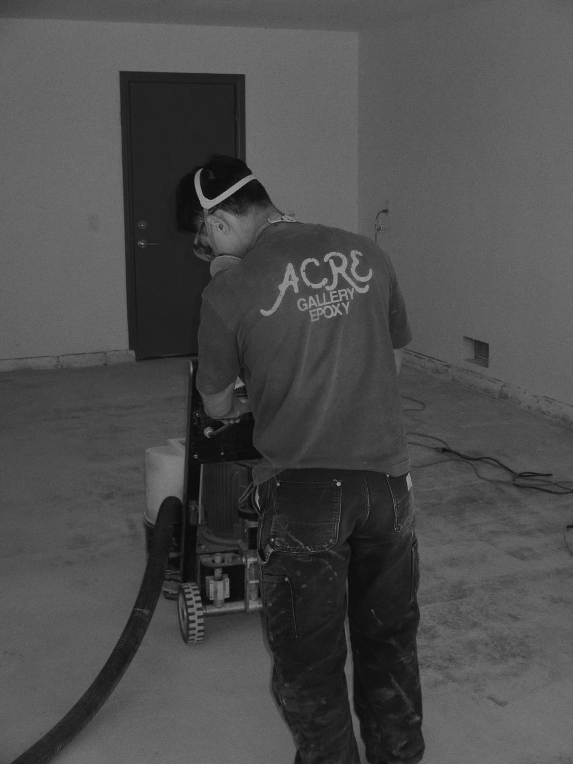 Grinding an epoxy floor on an ACRE Gallery Epoxy job site